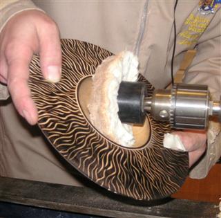 Polishing a bowl with a domed mop